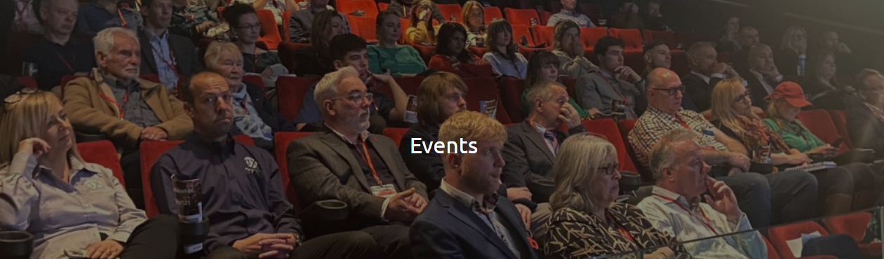 An audience gathered in a theatre for a Micro Business Alliance event